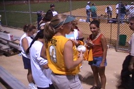 Kelley Pastic looks onto the field to get more autographs